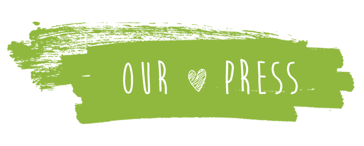 "Our Press" written in white with a heart drawing on a green background